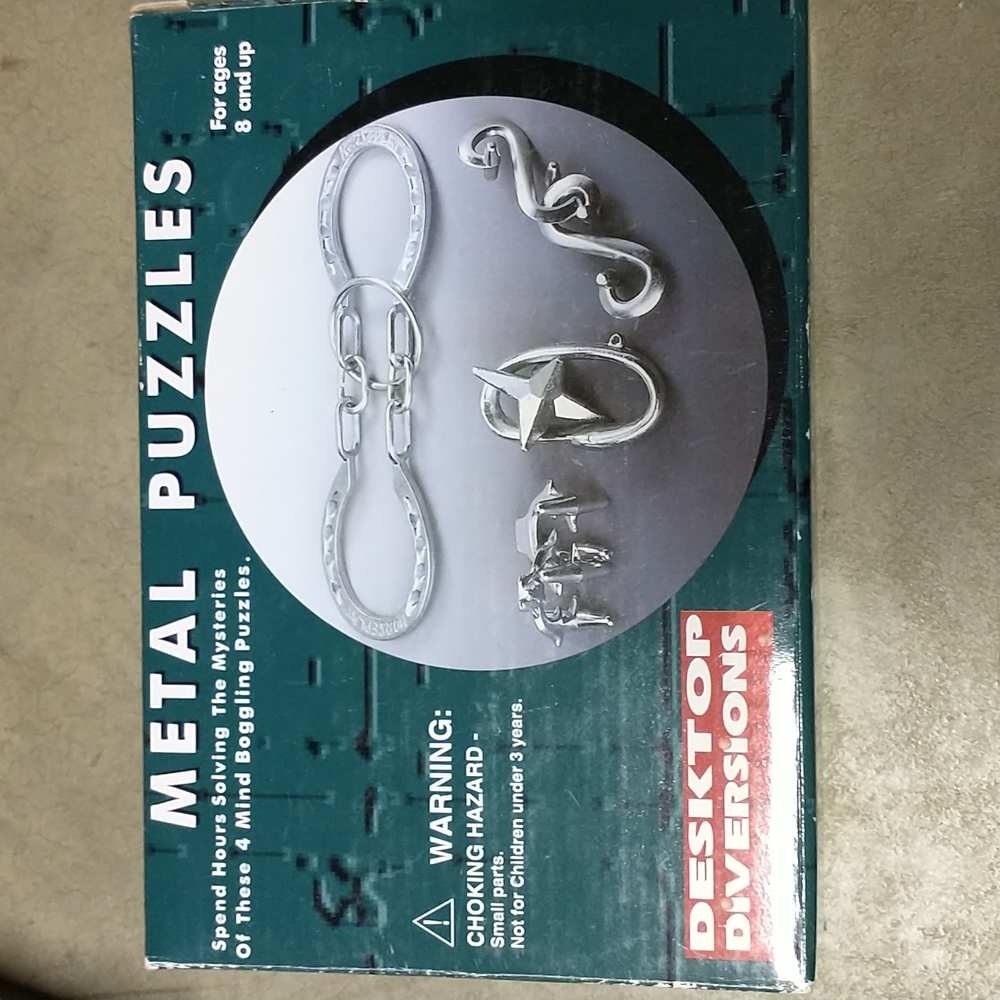 NWT 4 in 1 box challenging Metal Puzzles (with answers)